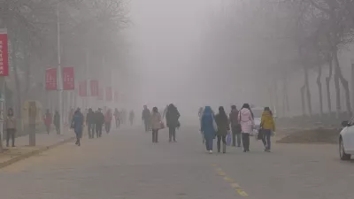 Students walk across a university campus in China in dense air pollution